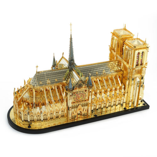 Detailed metal model of Notre Dame Cathedral with intricate architecture and golden finish.