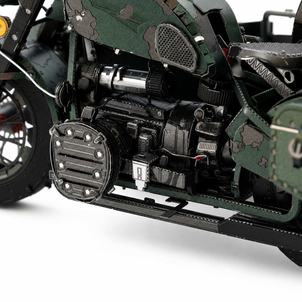 Close-up of a detailed motorcycle engine model with green camouflage paint.
