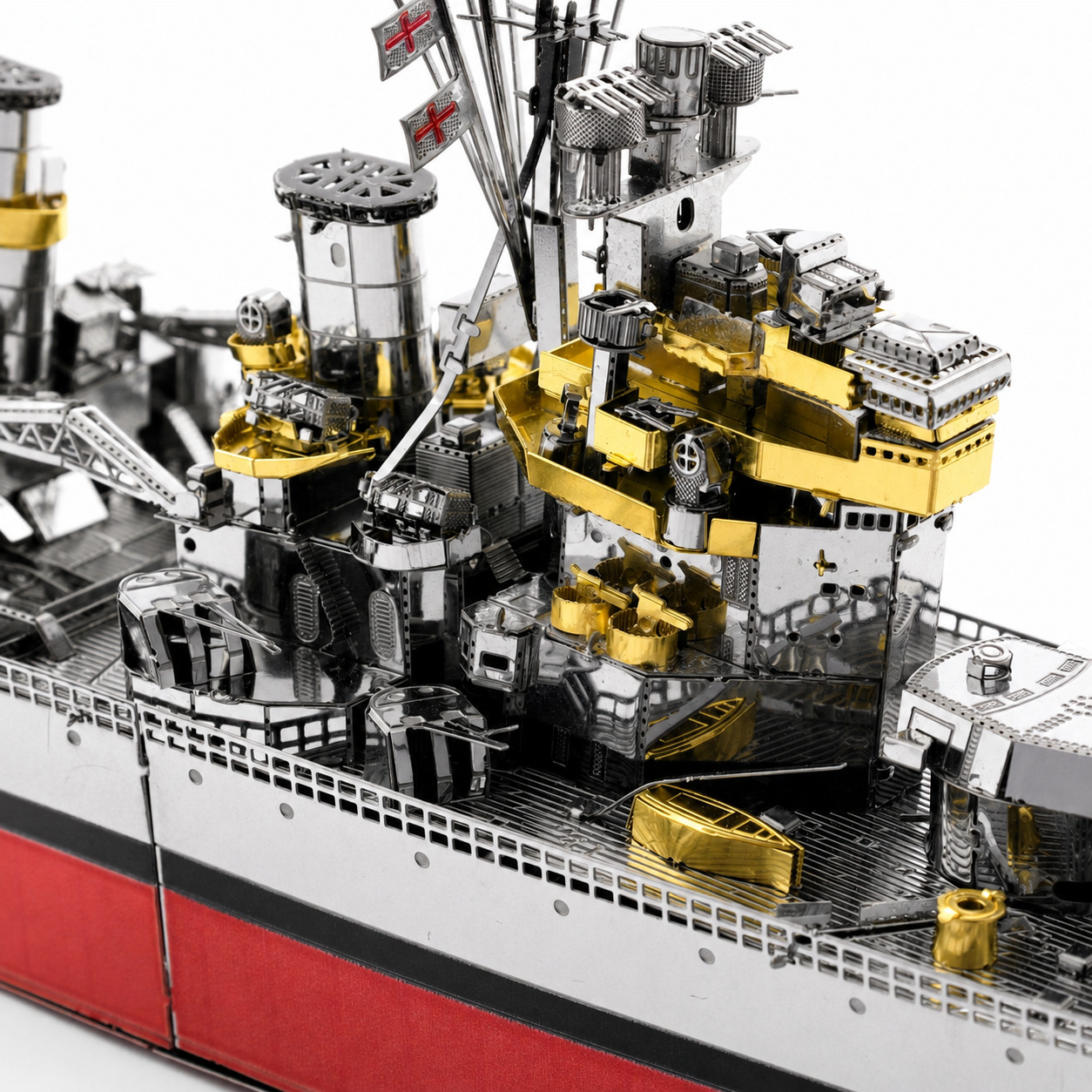 Detailed view of a metallic model ship with gold and silver elements.