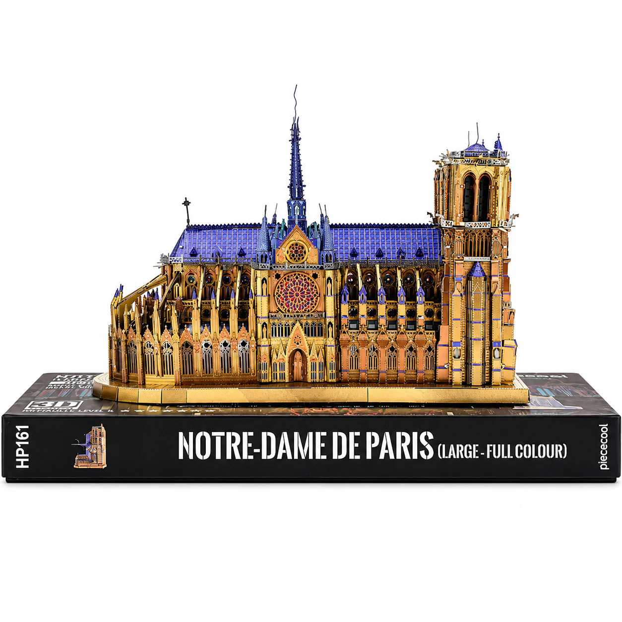 Detailed model of Notre-Dame de Paris on a book, showcasing intricate architecture.
