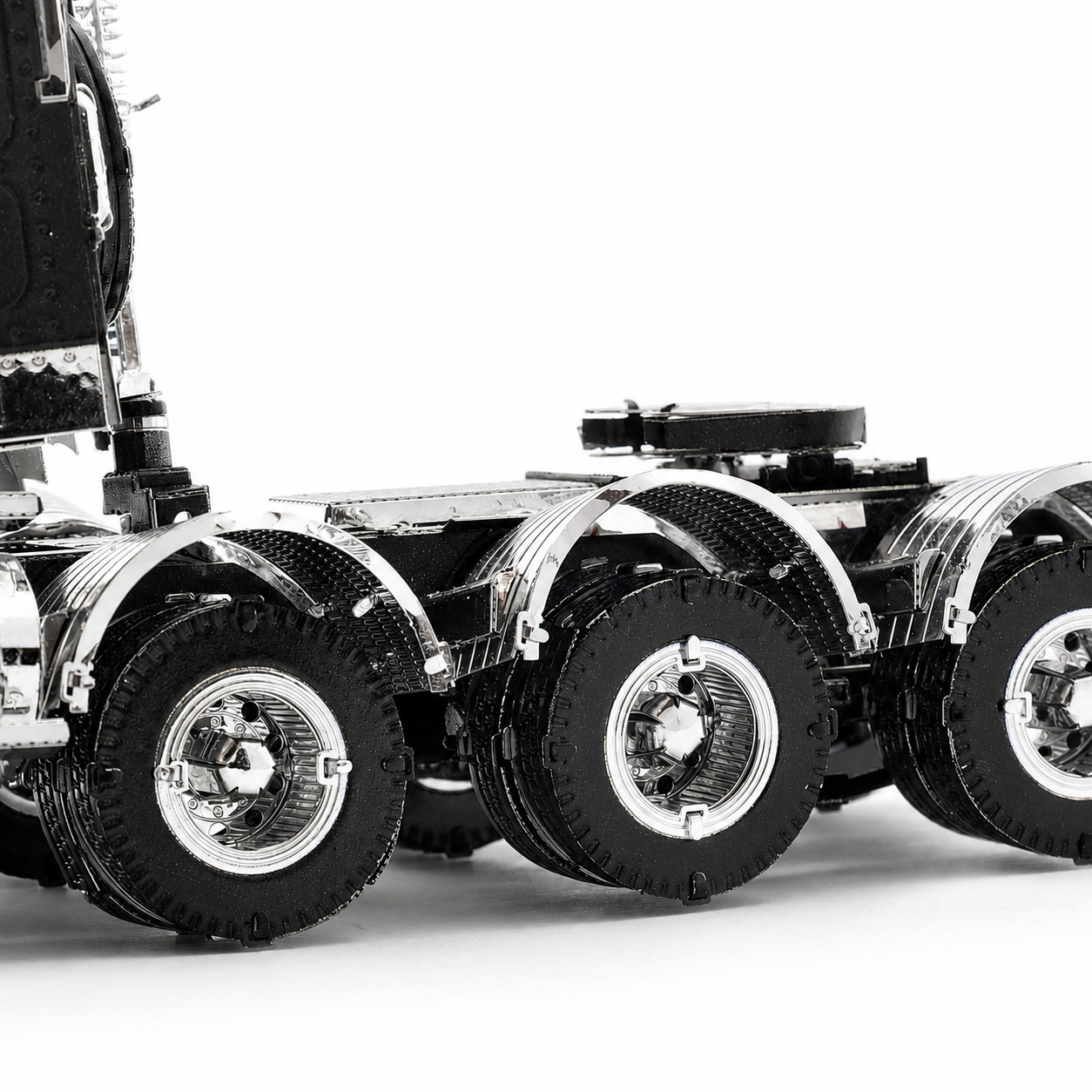 Close-up of a detailed model truck showing its wheels and chassis.