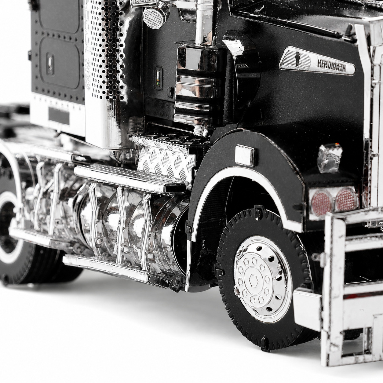 Close-up of a detailed black truck model showcasing its wheels and body features.
