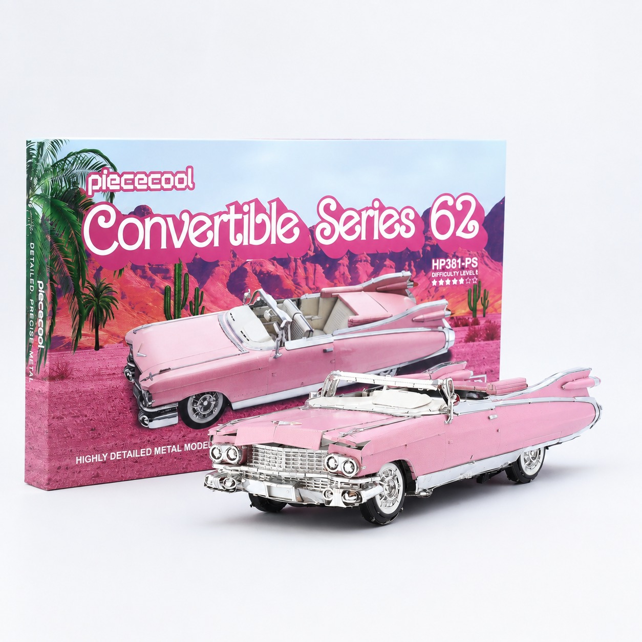 Detailed model of a pink convertible car with packaging in the background.